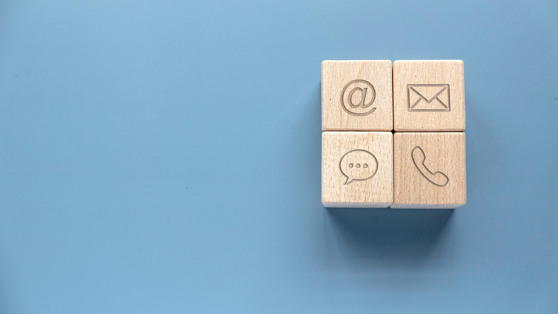 Icon of communication type on wooden cube. Contact us or Customer support hotline people connect.